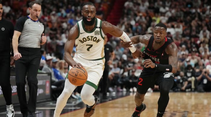 Boston Celtics guard Jaylen Brown drives past Miami Heat guard Terry Rozier during the first half at Kaseya Center in Miami on Feb. 11, 2024.